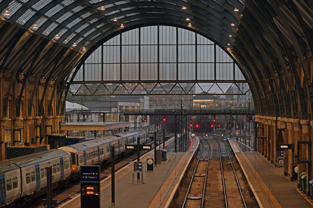 Kings Cross Train Station with a train waiting to depart on the left and an empty platform on the right.
